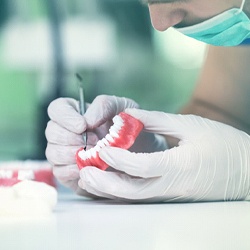 Dentist inspecting full dentures