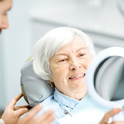 Woman smiling into mirror