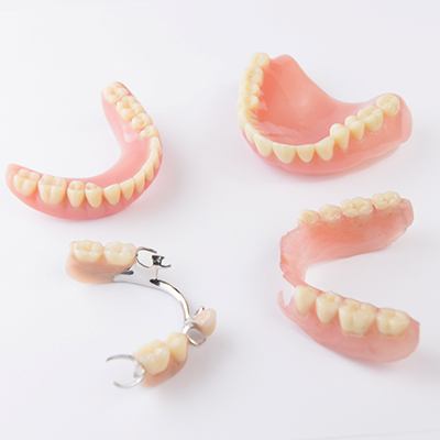 Several types of dentures on white background